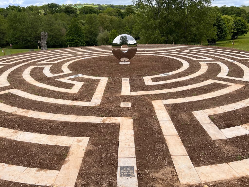 Large stone-paved labyrinth path laid into a Devon hillside by PC Landscaping