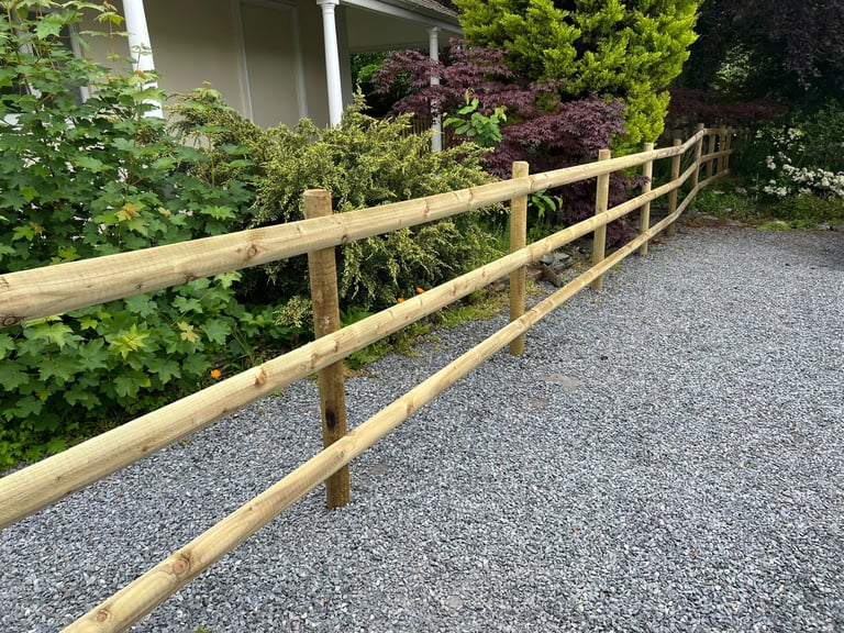 New timber post and rail fencing installed by PC Landscaping alongside a gravel drive in South Devon