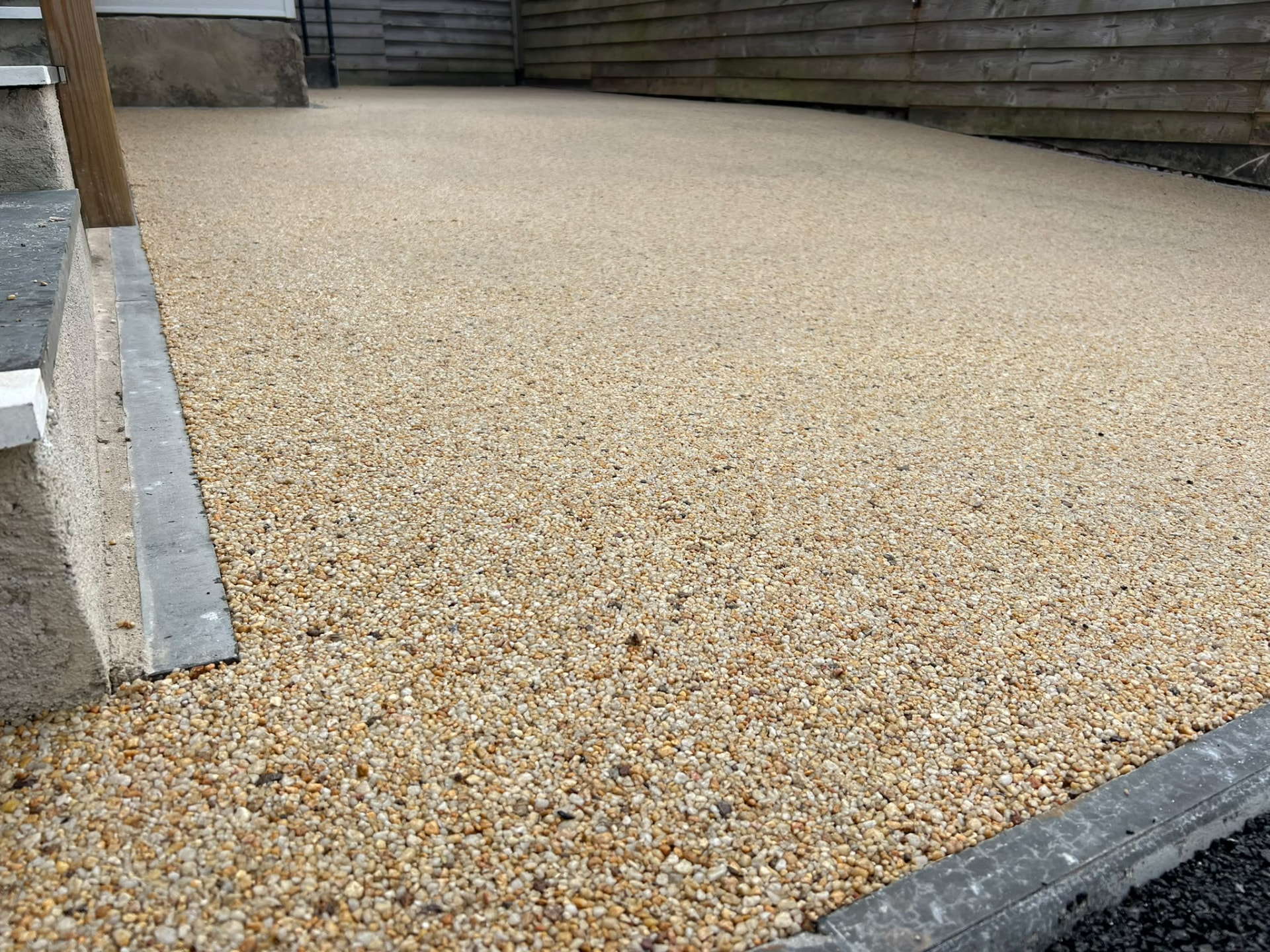 Resin-bound driveway laid by PC Landscaping at a property in South Devon, edged with kerbs