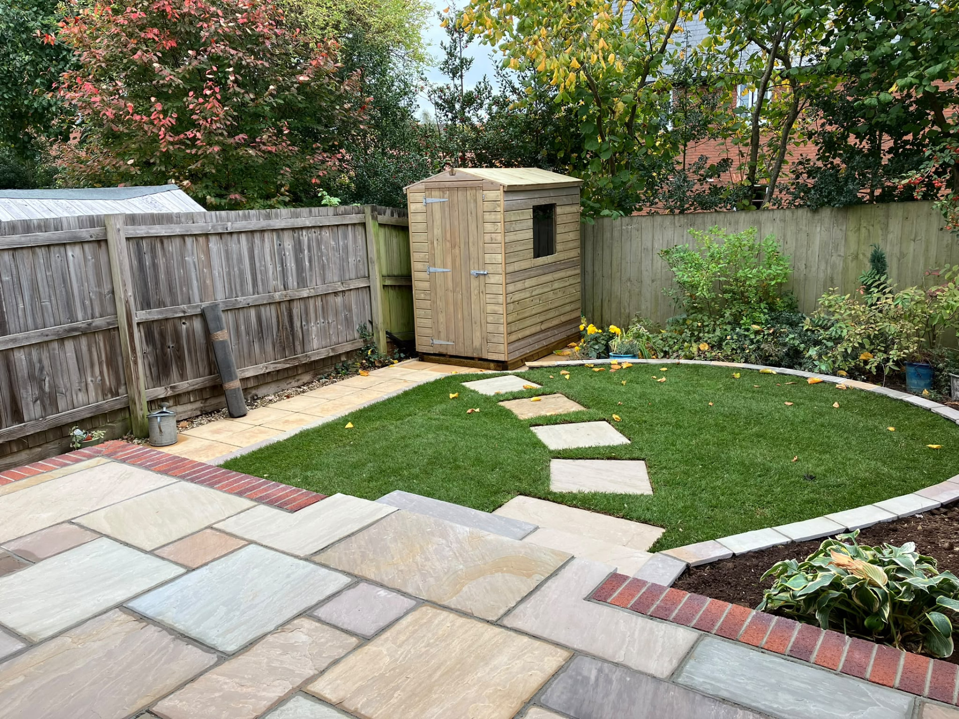 Patio laid by PC Landscaping at a home in South Devon, with level paving and a clean edge to the lawn