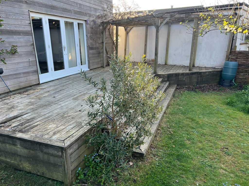 Indian sandstone patio on a rebuilt base, before