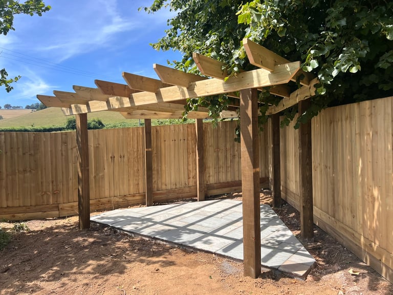 Timber pergola built by PC Landscaping over a patio in a South Devon garden